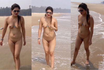 An Indian nude lady walks across the beach